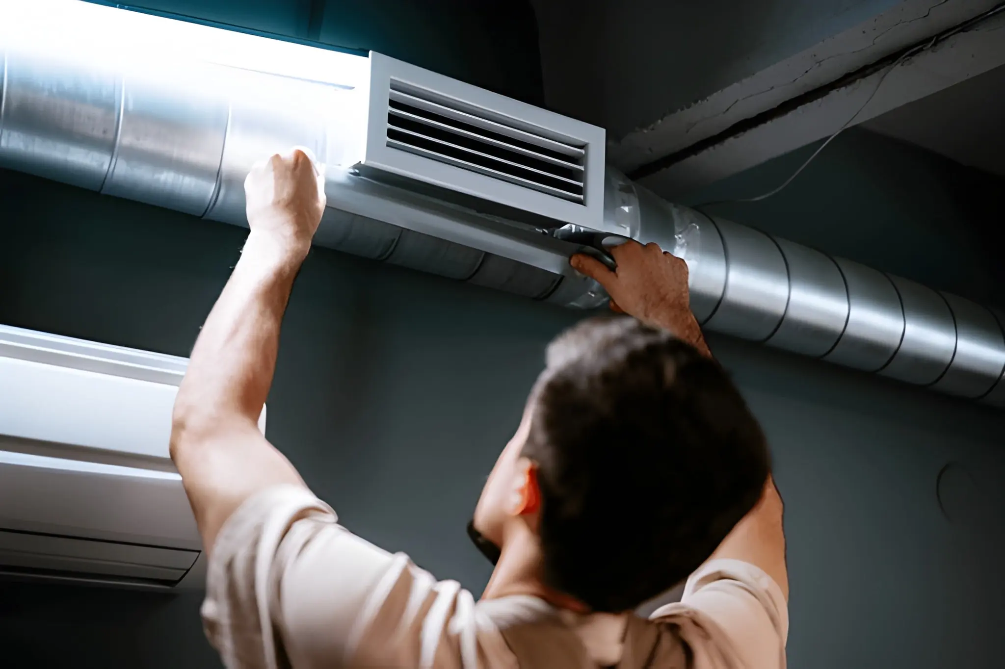 Technician repairing air ducts to fix leaks and improve HVAC airflow efficiency